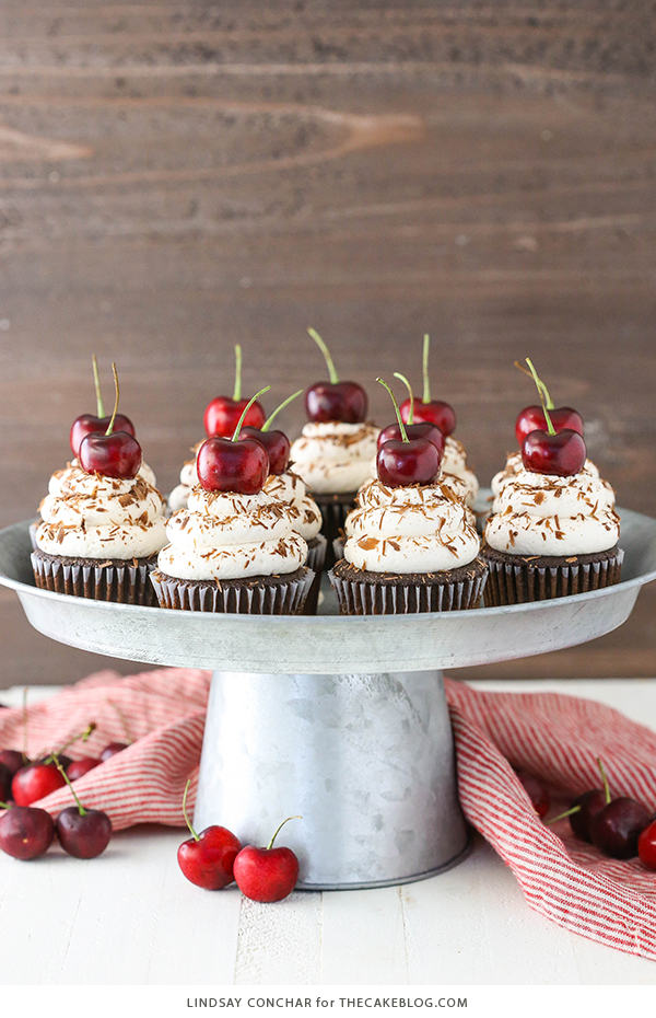 Black Forest Cupcakes - moist chocolate cupcake, homemade cherry filling and fresh vanilla whipped cream on top | by Lindsay Conchar for TheCakeBlog.com