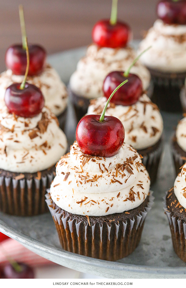 Black Forest Cupcakes - moist chocolate cupcake, homemade cherry filling and fresh vanilla whipped cream on top | by Lindsay Conchar for TheCakeBlog.com