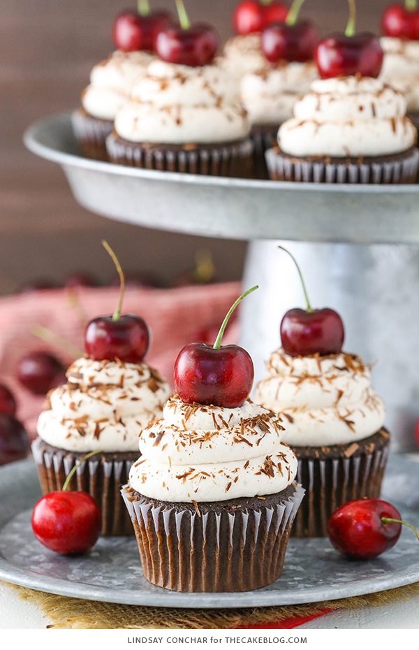 Black Forest Cupcakes - moist chocolate cupcake, homemade cherry filling and fresh vanilla whipped cream on top | by Lindsay Conchar for TheCakeBlog.com