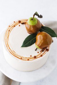 Salted Caramel Pear Cake - fresh pear cake with cinnamon buttercream, salted caramel and homemade caramel dipped pears | Carrie Sellman for TheCakeBlog.com
