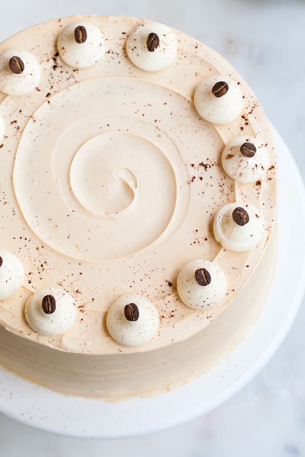 Caramel Cappuccino Cake - espresso cake paired with caramel buttercream frosting, topped with whole coffee beans and a sprinkle of cocoa powder | by Tessa Huff for TheCakeBlog.com