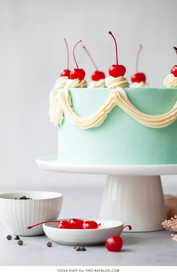 Cherry Chip Cake - maraschino cherry cake studded with chocolate chips, layered with chocolate ganache and finished with a whipped vanilla buttercream frosting | by Tessa Huff for TheCakeBlog.com