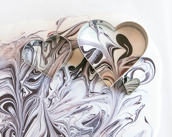 Marble Chocolate Hearts - how to make marbled heart toppers for cakes and cupcakes using chocolate coating and cookie cutters | by Erin Gardner for TheCakeBlog.com