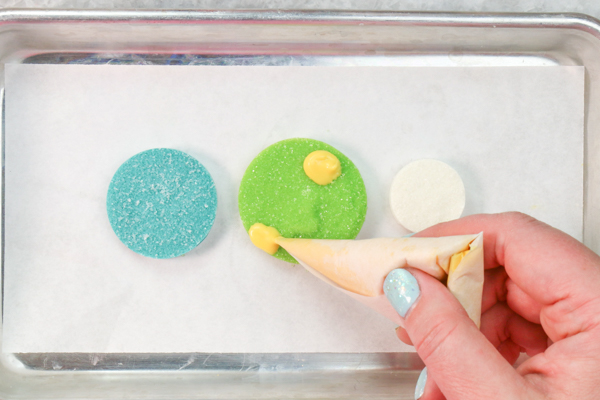 Sprinkle Ornament Cake – how to make sparkling ornaments for cakes and cupcakes using chocolate, cookie cutters and sprinkles | by Erin Gardner for TheCakeBlog.com