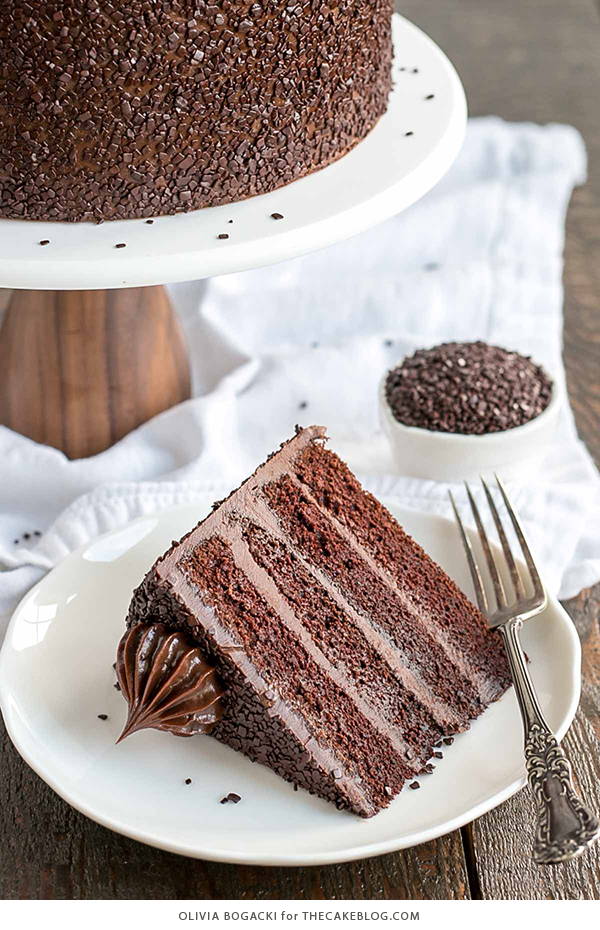 Chocolate Truffle Cake - a chocolate layer cake recipe with dense, moist chocolate cake, silky chocolate truffle frosting and chocolate flakes | by Olivia Bogacki for TheCakeBlog.com