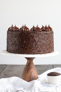 Chocolate Truffle Cake - a chocolate layer cake recipe with dense, moist chocolate cake, silky chocolate truffle frosting and chocolate flakes | by Olivia Bogacki for TheCakeBlog.com