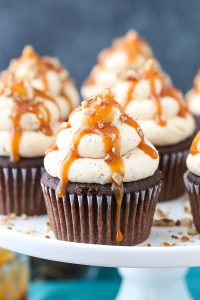 Chocolate Turtle Cupcakes - from scratch recipe for rich chocolate cupcakes with caramel pecan frosting, caramel drizzle and chopped pecans | by Lindsay Conchar for TheCakeBlog.com