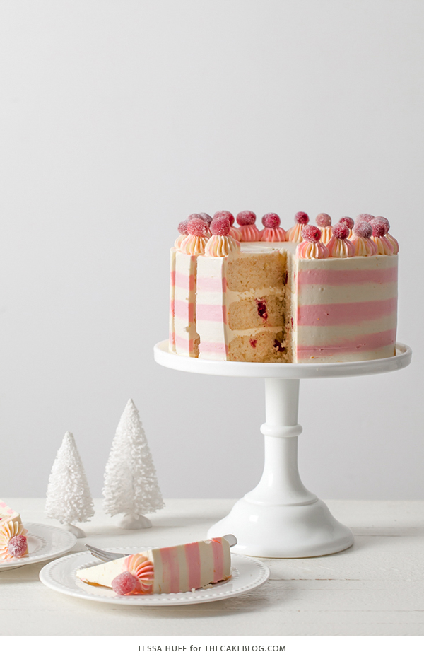 Cranberry Orange Spice Cake - orange cake studded with cranberries topped with white chocolate orange frosting in festive pink and white buttercream stripes | by Tessa Huff for TheCakeBlog.com