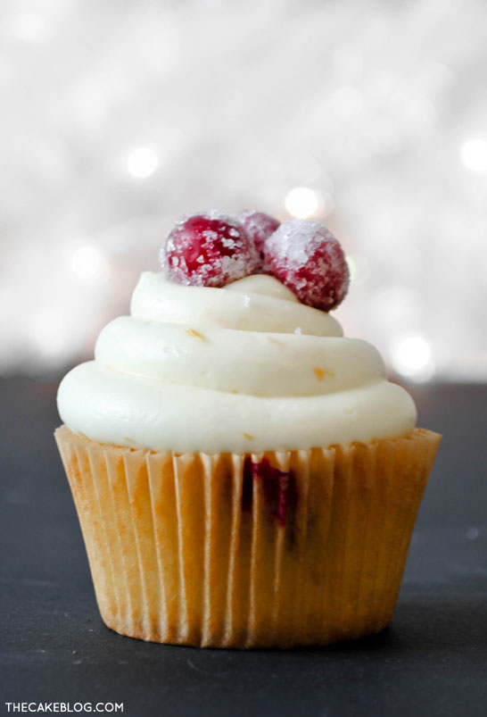 Cranberry Orange Cupcakes with sugared cranberries. Perfect for the holidays and Christmas dessert | Carrie Sellman for TheCakeBlog.com
