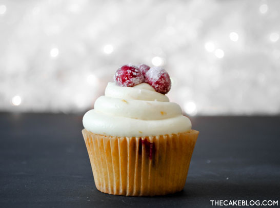 Cranberry Orange Cupcakes with sugared cranberries. Perfect for the holidays and Christmas dessert | Carrie Sellman for TheCakeBlog.com
