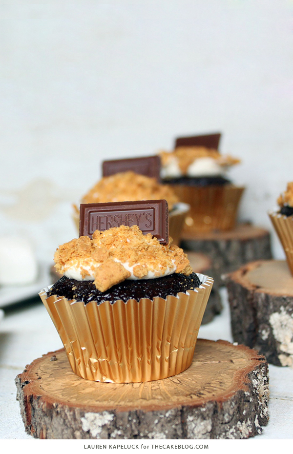 S'mores Cupcakes - easy s'more inspired cupcake recipe with chocolate cupcakes, marshmallow frosting, graham cracker crumbs and a hunk of milk chocolate | by Lauren Kapeluck for TheCakeBlog.com