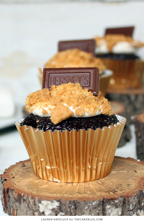 S'mores Cupcakes - easy s'more inspired cupcake recipe with chocolate cupcakes, marshmallow frosting, graham cracker crumbs and a hunk of milk chocolate | by Lauren Kapeluck for TheCakeBlog.com