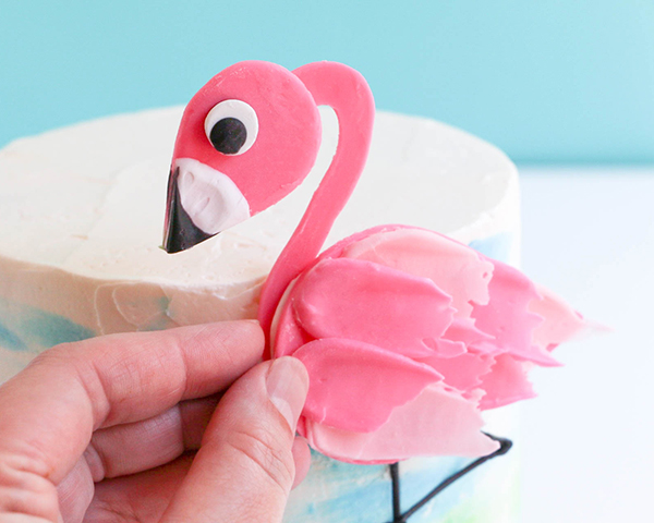 Flamingo Cake - how to make a pink flamingo cake topper using chocolate candy melts and brushstroke feathers | by Erin Gardner for TheCakeBlog.com