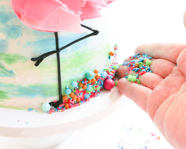 Flamingo Cake - how to make a pink flamingo cake topper using chocolate candy melts and brushstroke feathers | by Erin Gardner for TheCakeBlog.com