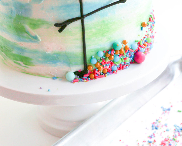 Flamingo Cake - how to make a pink flamingo cake topper using chocolate candy melts and brushstroke feathers | by Erin Gardner for TheCakeBlog.com