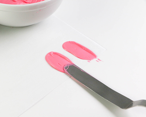 Flamingo Cake - how to make a pink flamingo cake topper using chocolate candy melts and brushstroke feathers | by Erin Gardner for TheCakeBlog.com