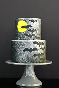 Learn how to make this Spooky Splatter Halloween Cake with flying bats | by Erin Gardner for TheCakeBlog.com