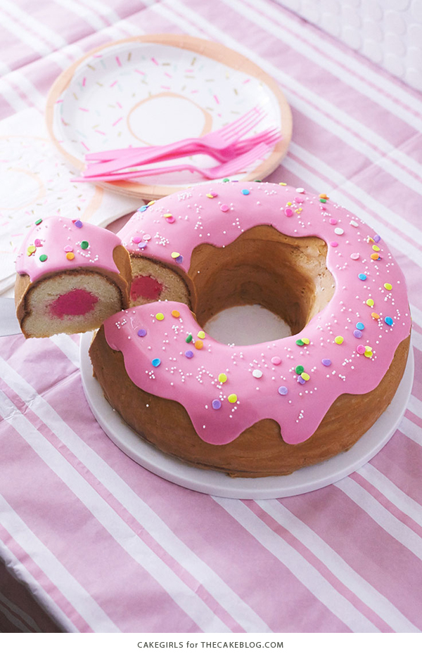 Giant Donut Cake! Learn how to make this adorable, sprinkle-coated, giant donut cake with a simple step-by-step tutorial | by Cakegirls for TheCakeBlog.com