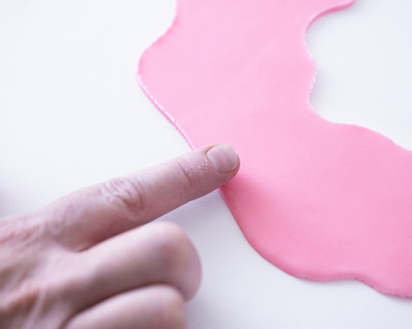 Giant Donut Cake! Learn how to make this adorable, sprinkle-coated, giant donut cake with a simple step-by-step tutorial | by Cakegirls for TheCakeBlog.com