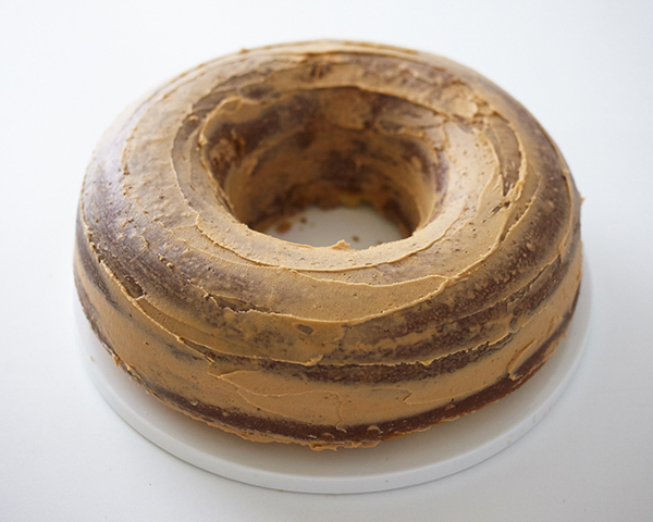 Giant Donut Cake! Learn how to make this adorable, sprinkle-coated, giant donut cake with a simple step-by-step tutorial | by Cakegirls for TheCakeBlog.com