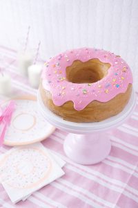 Giant Donut Cake! Learn how to make this adorable, sprinkle-coated, giant donut cake with a simple step-by-step tutorial | by Cakegirls for TheCakeBlog.com