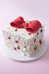 Holly Gift Box Cake! Learn how to make this festive gift box cake that looks just like a present | by Cakegirls for TheCakeBlog.com