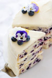 Lemon Blueberry Cake - lemon cake studded with wild blueberries, topped with lemon cream cheese frosting | by Carrie Sellman for TheCakeBlog.com