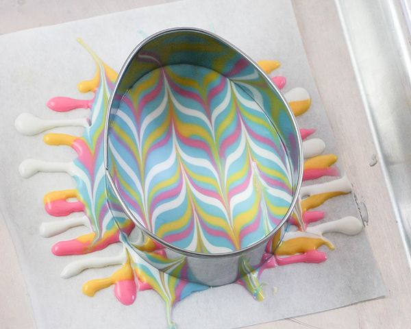 Marbled Chocolate Easter Eggs - how to make marbled Easter egg toppers for cakes and cupcakes using chocolate coating and cookie cutters | by Erin Gardner for TheCakeBlog.com