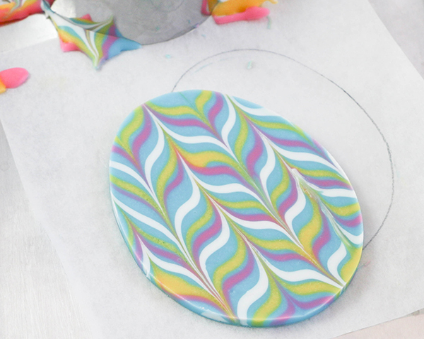 Marbled Chocolate Easter Eggs - how to make marbled Easter egg toppers for cakes and cupcakes using chocolate coating and cookie cutters | by Erin Gardner for TheCakeBlog.com