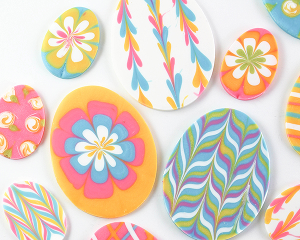 Marbled Chocolate Easter Eggs - how to make marbled Easter egg toppers for cakes and cupcakes using chocolate coating and cookie cutters | by Erin Gardner for TheCakeBlog.com