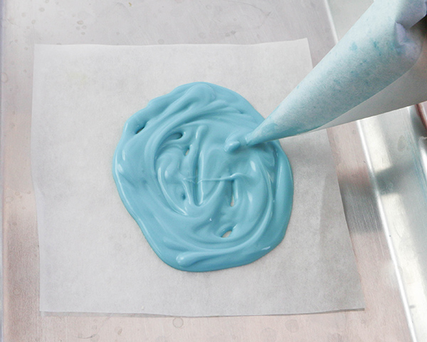 Marbled Chocolate Easter Eggs - how to make marbled Easter egg toppers for cakes and cupcakes using chocolate coating and cookie cutters | by Erin Gardner for TheCakeBlog.com