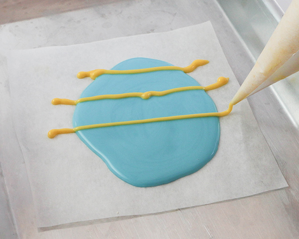 Marbled Chocolate Easter Eggs - how to make marbled Easter egg toppers for cakes and cupcakes using chocolate coating and cookie cutters | by Erin Gardner for TheCakeBlog.com