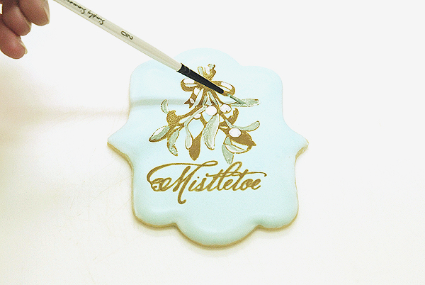 How to stencil-paint a cookie | Mistletoe Cookie Tutorial | by Robin Martin for TheCakeBlog.com