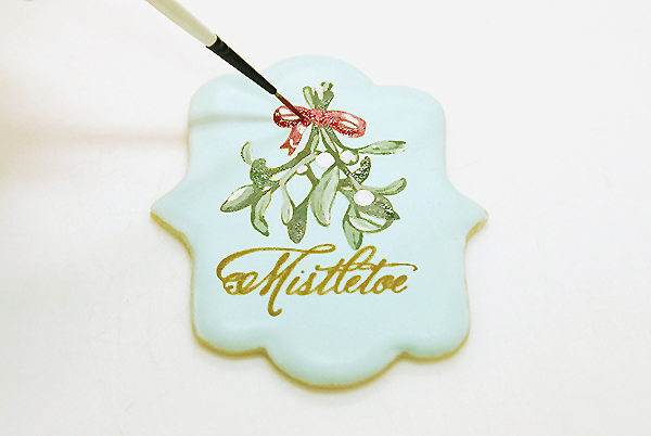 How to stencil-paint a cookie | Mistletoe Cookie Tutorial | by Robin Martin for TheCakeBlog.com