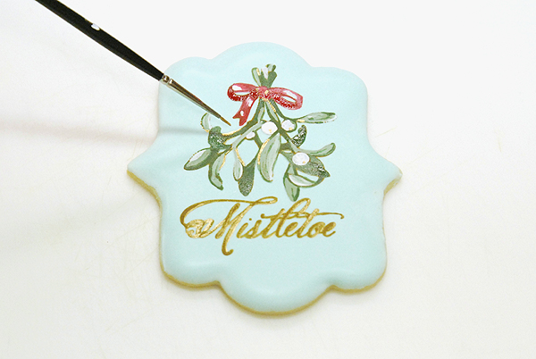 How to stencil-paint a cookie | Mistletoe Cookie Tutorial | by Robin Martin for TheCakeBlog.com