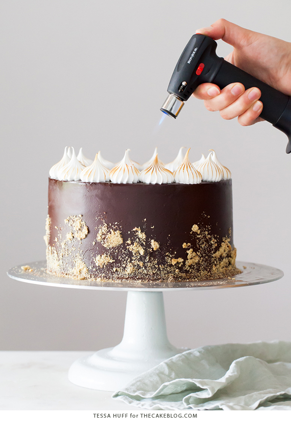 S'mores Cake - s'more inspired layer cake recipe with chocolate cake, graham cracker buttercream, chocolate ganache and toasted marshmallow meringue | by Tessa Huff for TheCakeBlog.com