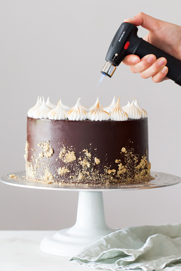 S'mores Cake - s'more inspired layer cake recipe with chocolate cake, graham cracker buttercream,  chocolate ganache and toasted marshmallow meringue | by Tessa Huff for TheCakeBlog.com