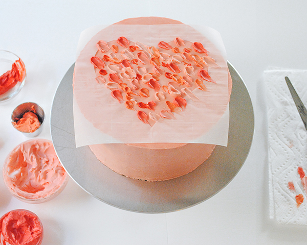 Watercolor Heart Cake - how to paint a watercolor heart cake using buttercream frosting and a parchment paper stencil | by Carrie Sellman for TheCakeBlog.com