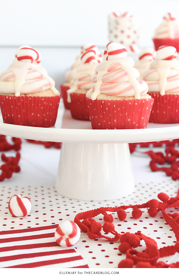 White Chocolate Peppermint Cupcakes - delicious white cake speckled with candy canes, topped with red and white swirled buttercream and white chocolate ganache | by ellenJAY for TheCakeBlog.com