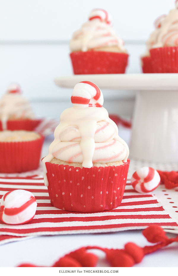 White Chocolate Peppermint Cupcakes - delicious white cake speckled with candy canes, topped with red and white swirled buttercream and white chocolate ganache | by ellenJAY for TheCakeBlog.com