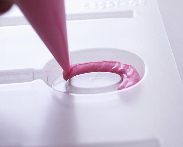 XOXO Valentine's Day Cake - how to make a pink ombre striped cake decorated with chocolate lips, hearts and an XOXO topper | by Cakegirls for TheCakeBlog.com